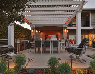 Infratech slimline patio heater heats a patio under an arbor.